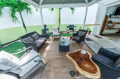 a living room with a couch and chairs and a table at Villa Luna Nueva by Vacation Pura Vida in Esterillos