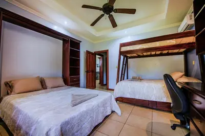 a bedroom with two beds and a ceiling fan at Villa Brisa Del Mar by Vacation Pura Vida in Esterillos