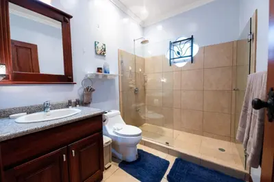 a bathroom with a shower and a toilet and a sink at Villa Brisa Del Mar by Vacation Pura Vida in Esterillos