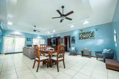 a living room with a table and chairs and a couch at Villa Brisa Del Mar by Vacation Pura Vida in Esterillos