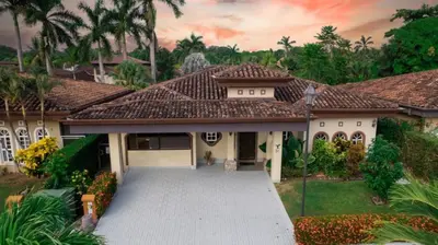 a house with a driveway in front of it at Villa Brisa Del Mar by Vacation Pura Vida in Esterillos