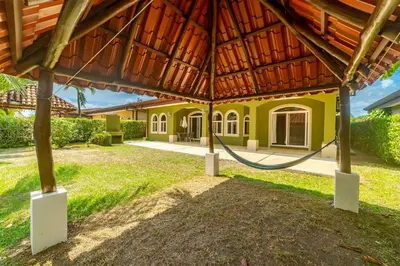 a house with a hose in a yard at Villa San Miguel by Vacation Pura Vida in Bejuco