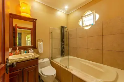 a bathroom with a tub and a toilet and a sink at Villa San Miguel by Vacation Pura Vida in Bejuco