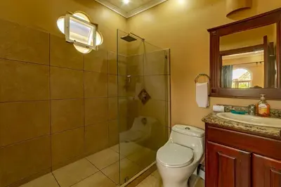 a bathroom with a shower and a toilet and a sink at Villa San Miguel by Vacation Pura Vida in Bejuco