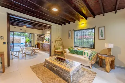 a living room with a couch and a table at Villa Tenga Paz by Vacation Pura Vida in Esterillos