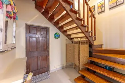 a hallway with a wooden door and stairs at Villa Tenga Paz by Vacation Pura Vida in Esterillos