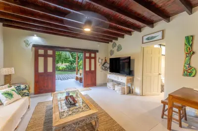 a living room with a couch and a table at Villa Tenga Paz by Vacation Pura Vida in Esterillos
