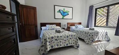 a bedroom with two beds and a window at Villa Pura Vida - All Inclusive in Ocotal
