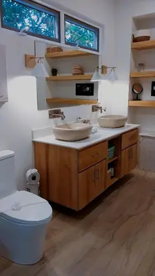 a bathroom with two sinks and a toilet at Casa Arribada- Bright 4Br House 5-min walk to Beach, Pool, BBQ in Playa Flamingo