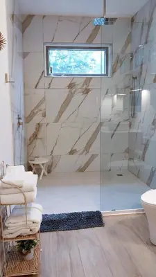 a bathroom with a glass shower and a toilet at Casa Arribada- Bright 4Br House 5-min walk to Beach, Pool, BBQ in Playa Flamingo