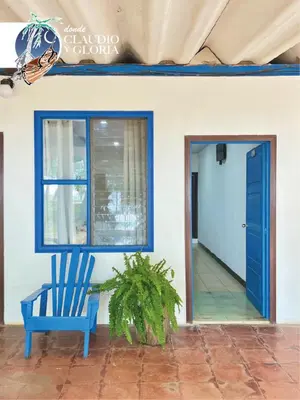 a blue chair sitting in front of a house at Hotel Claudio y Gloria in Coco