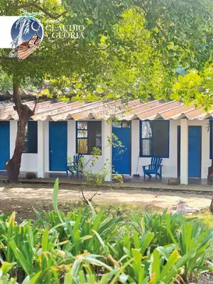 a blue and white building with a bench in front of it at Hotel Claudio y Gloria in Coco