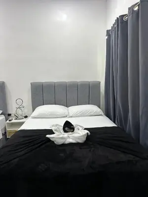 a bed with a towel on top of it at H et L in Tortuguero