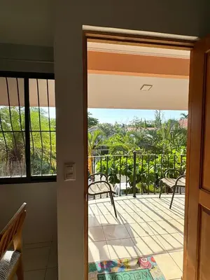 a door to a balcony with a view of the ocean at Happy Oasis Second Floor Condo with Terrace in Coco