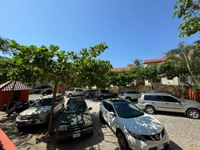 a row of cars parked in a parking lot at Happy Oasis Second Floor Condo with Terrace in Coco