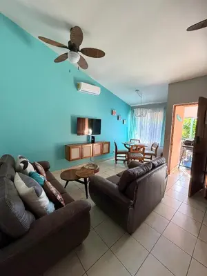 a living room with two couches and a ceiling fan at Happy Oasis Second Floor Condo with Terrace in Coco