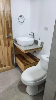 a bathroom with a white toilet and a sink at SamaraLofts near town and beaches in Sámara
