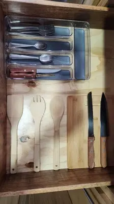 a drawer filled with wooden utensils on a table at SamaraLofts near town and beaches in Sámara