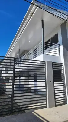 a white building with a gate and stairs on it at SamaraLofts near town and beaches in Sámara