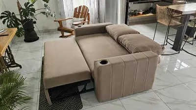 a brown couch sitting in a living room at Mi casa, tu casa Manuel Antonio, Quepos in Quepos