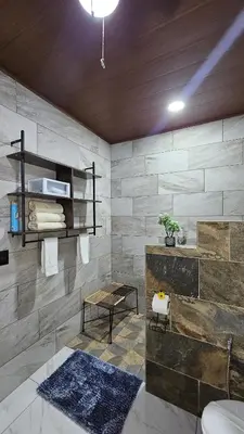 a bathroom with a sink and a toilet and a table at Mi casa, tu casa Manuel Antonio, Quepos in Quepos