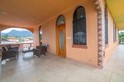 a porch with chairs and a door and a table at FORTUNA FLAT#2, Luxury & Top View in Fortuna