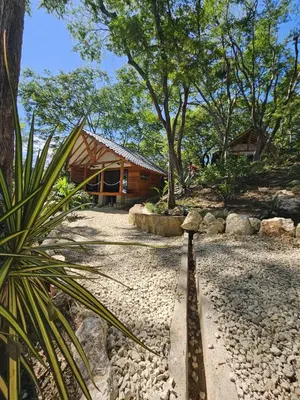 a house with a gravel yard in front of it at Beach resort playa Leona in Gigantes