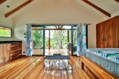 a bedroom with a bed and a large sliding glass door at Beach resort playa Leona in Gigantes