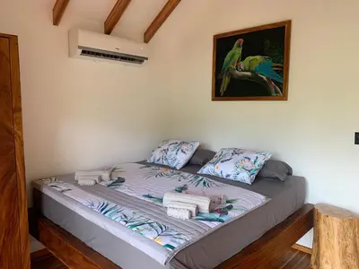 a bed in a room with a picture on the wall at Beach resort playa Leona in Gigantes