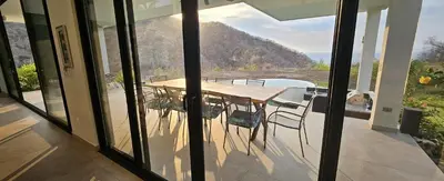 a table and chairs on a balcony with a view at El Coco Oasis Where Luxury Meets Nature! in Sardinal