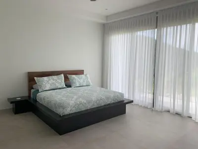 a bedroom with a bed and a large window at El Coco Oasis Where Luxury Meets Nature! in Sardinal