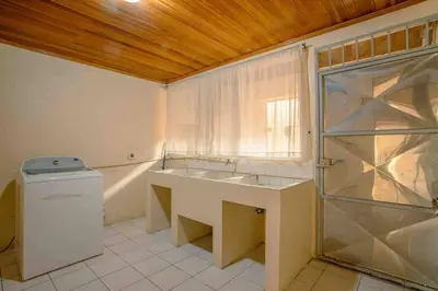 a bathroom with a sink and a washing machine at FORTUNA FLAT #1 BEST VALUE & Cozy in Fortuna