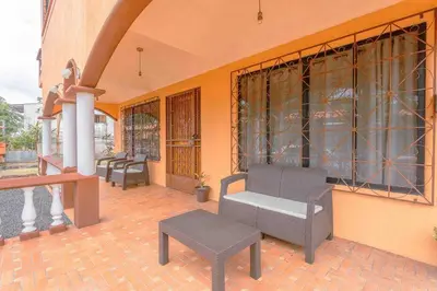 a patio with chairs and a bench on a building at FORTUNA FLAT #1 BEST VALUE & Cozy in Fortuna