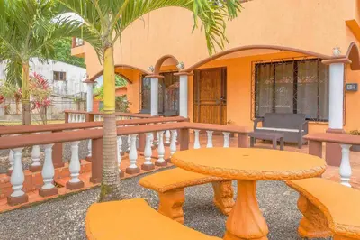 a table and a palm tree on a balcony at FORTUNA FLAT #1 BEST VALUE & Cozy in Fortuna