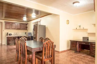 a kitchen with a table and chairs and a refrigerator at FORTUNA FLAT #1 BEST VALUE & Cozy in Fortuna