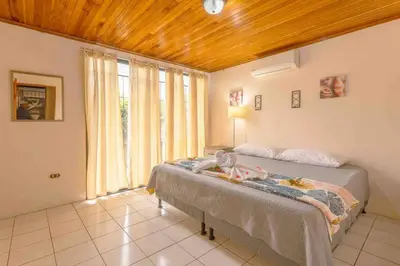 a bedroom with two beds and a large window at FORTUNA FLAT #1 BEST VALUE & Cozy in Fortuna