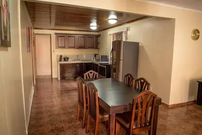 a kitchen with a table and chairs and a refrigerator at FORTUNA FLAT #1 BEST VALUE & Cozy in Fortuna