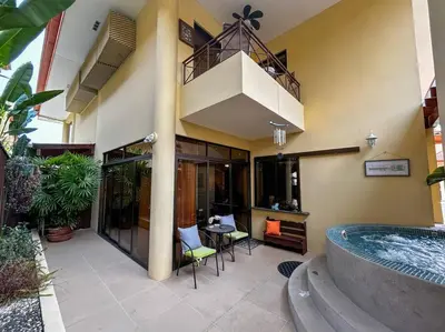 a house with a swimming pool and a patio with chairs at Beautiful Family Villa near Punta Leona in Quebrada Ganado