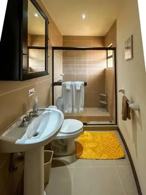 a bathroom with a sink and a toilet and a shower at Beautiful Family Villa near Punta Leona in Quebrada Ganado