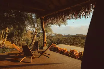 two chairs sitting on a wooden deck with a view at Casa Azafan - Amazing Sunsets in Garza
