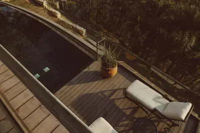 a deck with two chairs and a potted plant at Casa Azafan - Amazing Sunsets in Garza