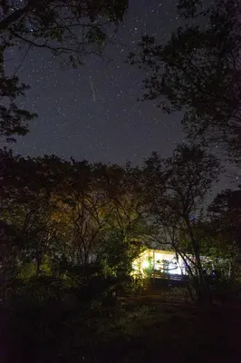 a starry night with a building and some trees at Marbella Retreats Casa Azul in Santa Cruz