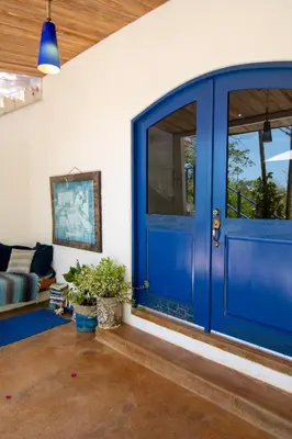 a blue door in a living room with a couch at Marbella Retreats Casa Azul in Santa Cruz
