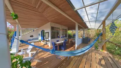 a hammock on a porch of a house at Marbella Retreats Casa Azul in Santa Cruz