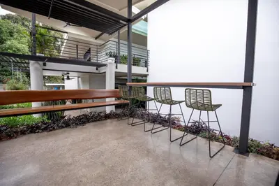 a row of chairs sitting on a balcony at Nomad Living CR Tárcoles in Tarcoles