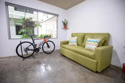 a bike is parked next to a couch at Nomad Living CR Tárcoles in Tarcoles