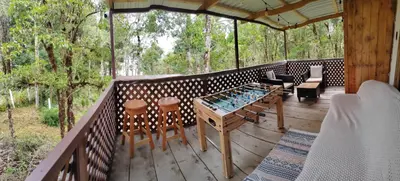 a wooden deck with a table and chairs on it at Cabaña Lugar de paz in Villa Mills