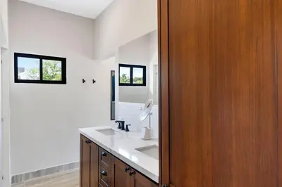 a bathroom with a sink and a mirror at Villa with Minimalist Design & Scenic Deck with Private Infinity Pool and Jungle Views in Coco