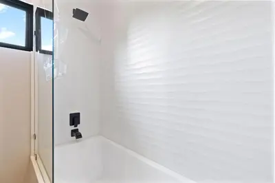 a bathroom with a shower with a glass door at Villa with Minimalist Design & Scenic Deck with Private Infinity Pool and Jungle Views in Coco