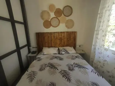 a bedroom with a bed with a black and white comforter at Casa Paraíso in Manzanillo